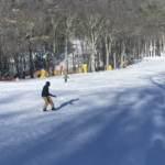 A snowboarder cruises down the hill at Cataloochee's opening day.